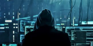 Cyber attack concept photo. Hacker in a hoodie sitting in front of multiples monitors. Photo by laddlajutt1722 from pixabay via Canva Pro / NHA File Photo