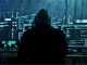 Cyber attack concept photo. Hacker in a hoodie sitting in front of multiples monitors. Photo by laddlajutt1722 from pixabay via Canva Pro / NHA File Photo