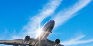 Photo for illustrative purposes only. Aircraft flying mid air against blue sky and strips of white clouds. | Photo by gyro / Getty Images (via Canva Pro) / NHA File Photo