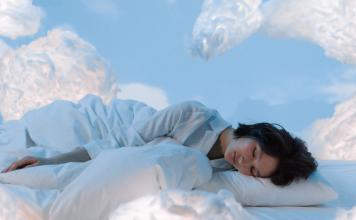 Photo of a woman sleeping near fluffy clouds. Photo for illustrative purposes only. | Photo by Ron Lach / Pexels (via Canva Pro) / NHA File Photo